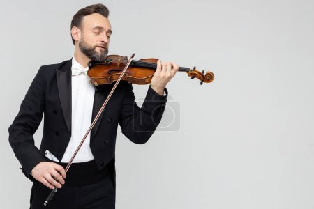 Photo for Musician man with violin performing concert isolated over light gray background, copy space - Royalty Free Image