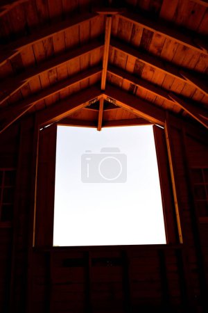 Photo for The open door to a hayloft portrays also the hip roofed style of a barn. - Royalty Free Image