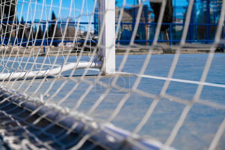 Photo for Floor of a soccer field with the goal net out of focus in a city - Royalty Free Image