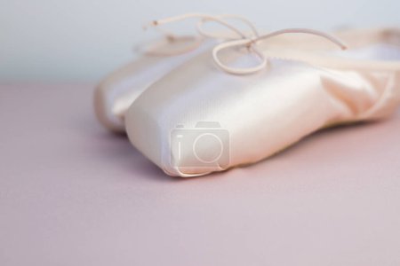 Photo for Pink pointe shoes for ballet close-up on a pink background. Space for text, side view. - Royalty Free Image