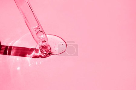 Photo for Hyaluronic acid with a dropper on a pink background. Side view. - Royalty Free Image