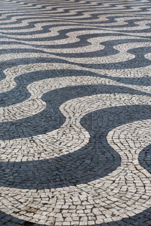 Photo for The traditional black and white paved tiles on the floors in many areas of Lisbon, Portugal - Royalty Free Image