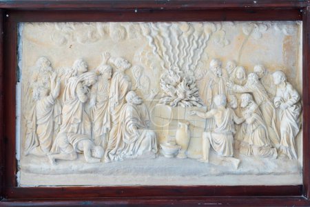 Photo for HAIFA, ISRAEL. June 26, 2022: Muhraka monastery of the Carmelite on the Carmel mount . Bas-relief depicting the priests of Baal at the altar and prophet Elijah - Royalty Free Image