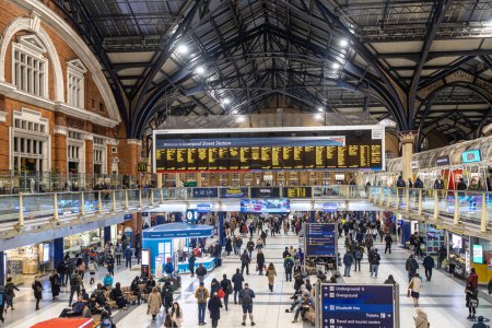 Photo for London England - February 17, 2022: A Busy station concourse at London Liverpool Street station with a crowd of people running to catch their train. - Royalty Free Image