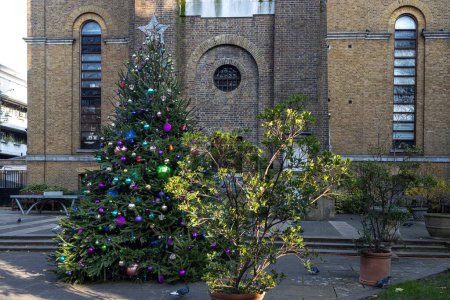 Photo for Christmas tree decorated in the courtyard of a medieval church - Royalty Free Image