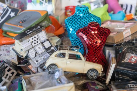 Photo for BARCELONA - March 14 2023: Typical stall on Els Encants flea market at Placa de les Gloriesa. Blue and red mannequin decorated with glass pieces, Peugeot children's car. - Royalty Free Image