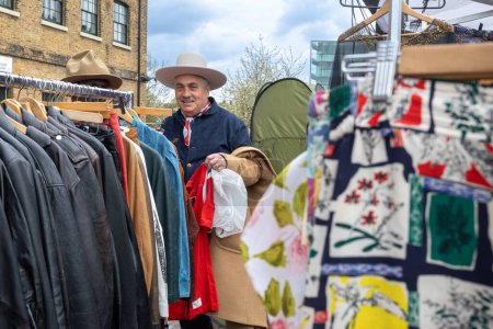 Photo for London UK - April 15 2023: Classic Car Boot Sale by Vintage. Retro festival. People selling vintage clothing, goods jewellery, homeware on their classic vehicles. Fifties style. - Royalty Free Image