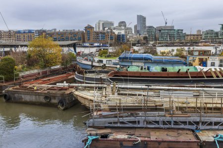 Photo for London, UK - 20 December 2023, The Tower Bridge and the London Skyline. Butler's Wharf Pier with views of Tower Bridge, a base for River Thames cruises - Royalty Free Image
