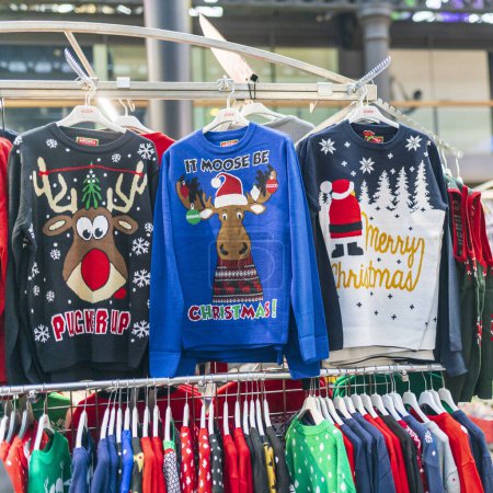 Photo for London, UK - December 2nd, 2023. A temporary seasonal display of ugly Christmas sweaters at a retail store. - Royalty Free Image