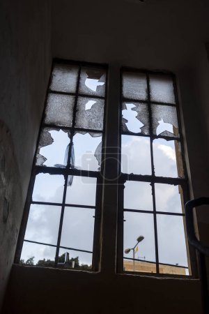 Photo for Broken window in an old house built in the constructivist style - Royalty Free Image