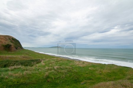 Photo for Green Cliffs at Te Waewae Bay with view of Pahia point at distance, The Catlins, Southland, New Zealand - Royalty Free Image
