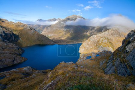 Photo for Deep Blue High Altitude Lake Harris and rocky mountain peaks at Harris Saddle,  Routeburn Track Great Walk, New Zealand - Royalty Free Image