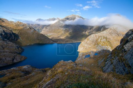 Photo for Deep Blue High Altitude Lake Harris and rocky mountain peaks at Harris Saddle,  Routeburn Track Great Walk, New Zealand - Royalty Free Image