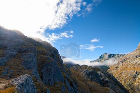 Photo for Bright sun light shining through cloud covered mountains, Mount Aspiring National Park, South Island New Zealand - Royalty Free Image