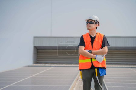 Photo for Asian engineers wearing protective vest and white hardhat standing crossed arms and looking to the copy space while holding tablet. - Royalty Free Image