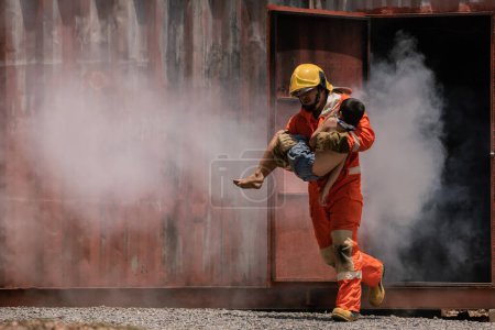 Photo for The firefighter bravely carried a child out of a smoke filled and dangerous place. - Royalty Free Image