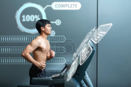 Photo for Handsome young man exercise on the treadmill with a smile, Graph shows the results of the system of the body, Health technology. - Royalty Free Image