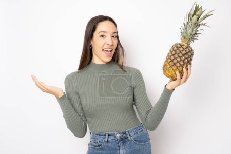 Photo for Young happy woman with pineapple isolated over white background. - Royalty Free Image