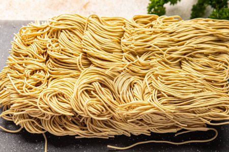 Photo for Egg noodles raw product durum wheat and soft wheat fresh delicious snack healthy meal food snack diet on the table copy space food background rustic top view - Royalty Free Image