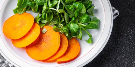Photo for Salad persimmon green lettuce fresh meal food snack on the table copy space food background rustic top view - Royalty Free Image