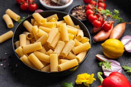 Photo for Rigatoni raw pasta meal other ingredients food snack on the table copy space food background - Royalty Free Image