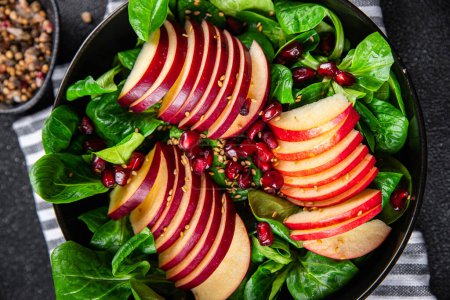 Photo for Apple salad, green mix lettuce, pomegranate grain healthy meal food snack on the table copy space food background rustic top view keto or paleo diet veggie vegan or vegetarian food - Royalty Free Image