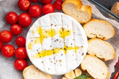 cheese baked Brie or Camembert, tomato, garlic and herbs healthy meal food snack on the table copy space food background rustic top view