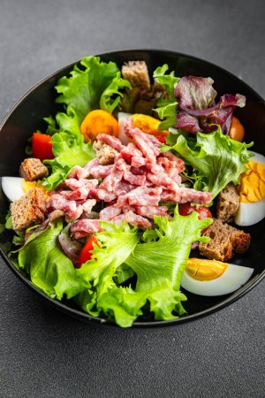 Photo for Bacon salad, Vosges salad, egg, crouton, lettuce, salad dressing vinaigrette Lorraine cuisine healthy meal food snack on the table copy space food background rustic top view - Royalty Free Image