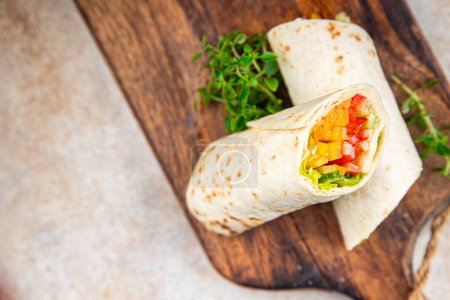 Photo for Tortilla vegetable burrito fajita shawarma with vegetables pita healthy meal food snack on the table copy space food background rustic top view - Royalty Free Image