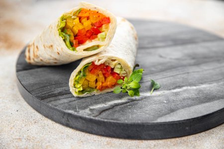 Photo for Tortilla wrap vegetable tacos vegetarian food burrito veganfajita shawarma vegetables pita healthy meal food snack on the table copy space food background rustic top view - Royalty Free Image