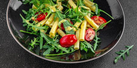 pasta salad tomato, arugula fresh food tasty eating cooking appetizer meal food snack on the table copy space food background rustic top view
