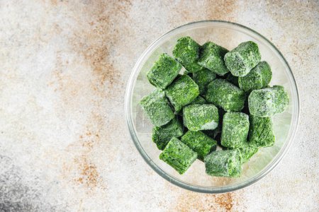 frozen spinach portion cube semifinished fresh food tasty healthy eating cooking meal snack on the table copy space food background rustic top view keto or paleo diet vegetarian vegan food