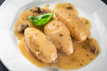 quenelles pork mushroom sauce canned food jar put food on a plate eating cooking appetizer meal food snack on the table copy space food background rustic top view