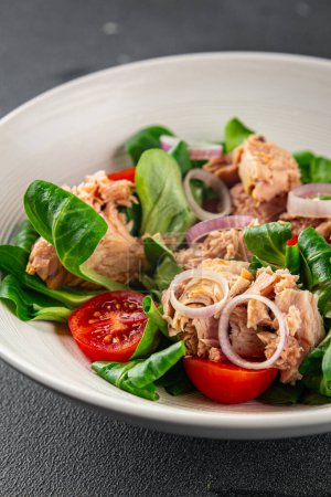tuna salad, tomato, green leaf lettuce, onion healthy eating cooking appetizer meal food snack on the table copy space food background rustic top view keto or paleo diet vegetarian food