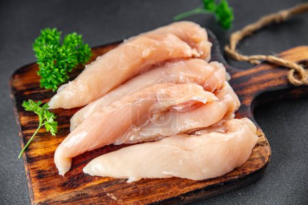 Photo for Raw chicken meat aiguillettes fresh cooking appetizer meal food snack on the table copy space food background rustic top view keto or paleo diet - Royalty Free Image