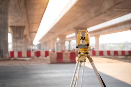 Photo for Theodolite located under the expressway for Civil Engineers at road construction site. Highway. Surveyor equipment. - Royalty Free Image