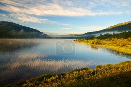 Photo for Dawn over Lake Yazevoe in eastern Kazakhstan.Lake Yazevoe is located at an altitude of 1685 meters above sea level. It is part of the State National Natural Park "Katon-Karagay". Dawn over a picturesque lake. - Royalty Free Image