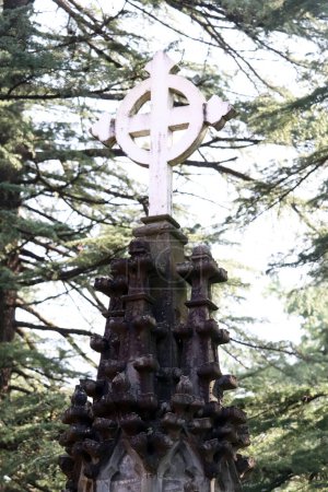 Photo for Old stone cross on the background of a cemetery in Dharamshala India - Royalty Free Image