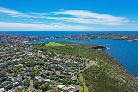 Photo for Beautiful high angle aerial drone view of Grotto Point and Washaway Beach in the suburb of Clontarf, Sydney, New South Wales, Australia. Manly and North Head in the background. - Royalty Free Image