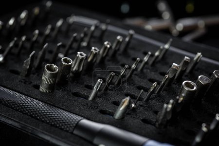 Screwdriver kit with aluminum bit driver on black tray. Driver handle with magnetic bit socket and knurled grip.