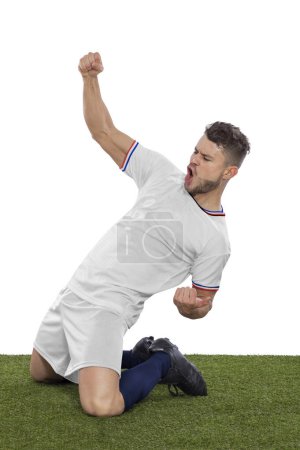 Photo for Professional soccer player with a white USA national team jersey shouting with excitement for scoring a goal with an expression of challenge and happiness on a white background. - Royalty Free Image