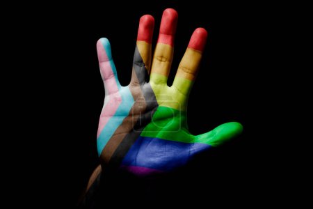 Rude man hand with flag of LGBT in stop sign to anger, discrimination, racism, abuse on black background.