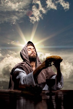 Photo for Jesus Christ praying to God w in the dark black night - Royalty Free Image
