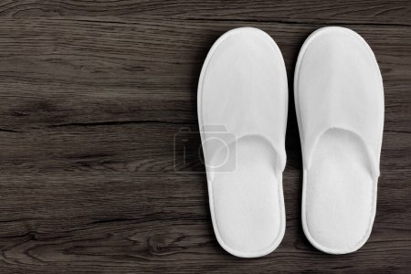 Photo for Spa, hotel - home slippers on wooden background with space for text - Royalty Free Image