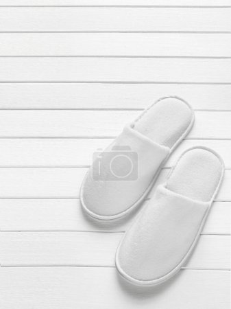 Photo for Close up view of white slippers. Balneo, spa, hotel, home concept - Royalty Free Image