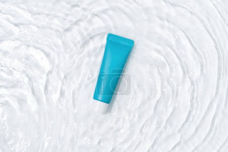 Blue moisturizer cream tube mockup lies on water with waves and white plain background. Concept of cosmetic products for skin care, beauty and spa. Image for your design