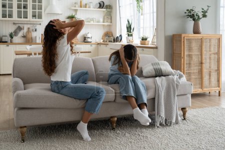 Photo for Stubborn teenage daughter wont listen mother, covering ears. Upset depressed mom parent of difficult teen girl feeling sad and frustrated after family fight. Tensions in parent-child relationship - Royalty Free Image