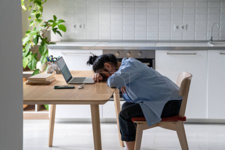 Photo for Tired Asian freelancer woman was exhausted from hard work at laptop take nap on table from overwork. High quality photo - Royalty Free Image