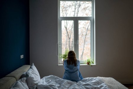 Photo for Depressed alone woman sit on bed at home pondering solution trouble, suffering from break up, divorce, feeling unwell. Loneliness girl think of psychological problem need help, regret about mistake. - Royalty Free Image
