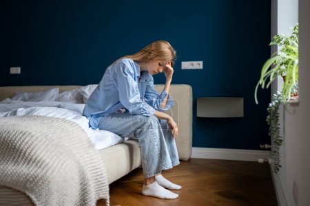 Photo for Exhausted girl thinking of psychological problem need help, regret about mistake. Depressed alone woman sit on bed at home pondering solution trouble, suffering from break up, divorce, feeling unwell. - Royalty Free Image